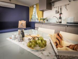 a table with a plate of grapes and bread on it at Holiday Home Miramare-1 by Interhome in Antignano