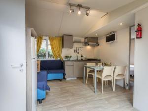 a small kitchen and dining room with a table and chairs at Holiday Home Miramare-1 by Interhome in Antignano