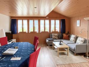 a living room with a couch and a table at Holiday Home Reindli by Interhome in Innertkirchen