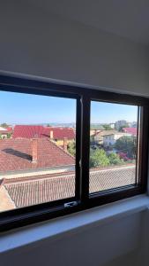 a window with a view of a roof at Lovely loft in Cluj-Napoca