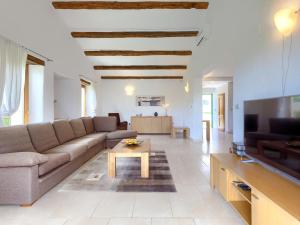 a living room with a couch and a tv at Villa Stuartma by Interhome in Donje Baredine