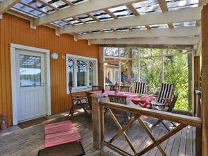 a patio with a table and a pergola at Holiday Home Lövkulla by Interhome in Löparö