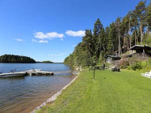a dock on a lake with a boat in the water at Holiday Home Lövkulla by Interhome in Löparö
