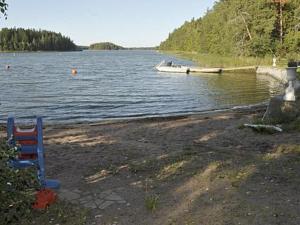 a boat is on the water with a beach at Holiday Home Lövkulla by Interhome in Löparö +42 photos