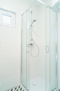 a shower with a glass enclosure in a bathroom at Arche Siedlisko Augustynka 59 