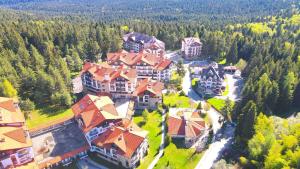 an aerial view of a large house with red roofs at Borovets Semiramida Garden Studio A16 in Borovets