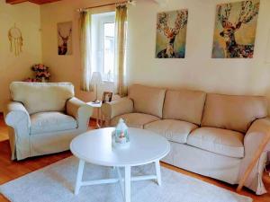 a living room with a couch and a table at Holiday Home Holiday Hill 42 by Interhome in Lauterwasser