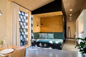 a bedroom with a bed in a room with a window at KOKON Apartments in Leutasch