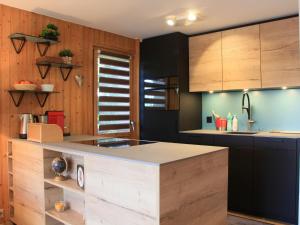 a kitchen with wooden cabinets and a counter top at Apartment Goeland n-4 by Interhome in Villars-sur-Ollon