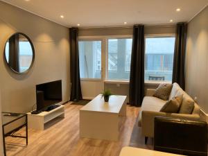 TV a/nebo společenská místnost v ubytování Parken Terrasse Apartment Hotel