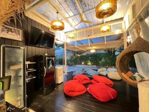 a room with a bunch of red pillows on the floor at Warm White Hua Hin House in Hua Hin