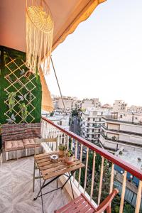 balcón con mesa y vistas a la ciudad en Vintage apartment in athens-zografou, en Atenas