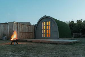 a dome tent with a fire in the yard at Glamping in Wiltshire the Green Knoll is a charm in Chippenham