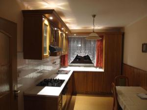 a kitchen with a stove and a window in it at Apartment Bajt in Králíky