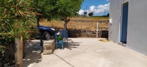 a car parked in the driveway of a house at Theros house in Kythira