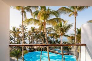 a view from the balcony of a resort with palm trees at Hotel Fariones in Puerto del Carmen