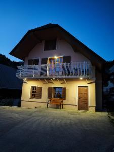 a large house with a balcony on top of it at House of relaxation in Zgornja Sorica
