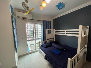 a bedroom with a bed and a large window at Galleria Equine Park - Studio in Seri Kembangan