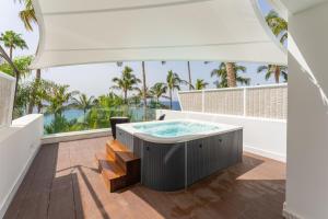 a hot tub on the balcony of a house at Hotel Fariones in Puerto del Carmen