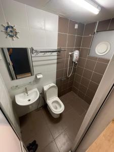 a bathroom with a toilet and a sink at Galleria Equine Park - Studio in Seri Kembangan