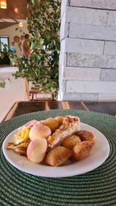 a white plate of food on a table at Arena Carneiros Hotel by AFT in Tamandaré