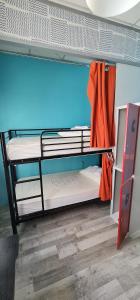 a room with two bunk beds with an orange towel at GREEN Hostel MADRID GRAN VIA in Madrid
