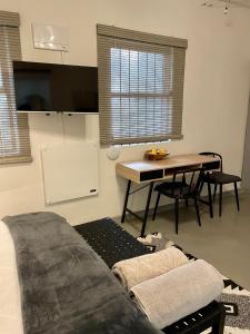 a living room with a couch and a table at Open Room Comfort in Cape Town