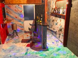 a bar in a room with a painting on the floor at Algreco Naturists & Swinging in Asgourou