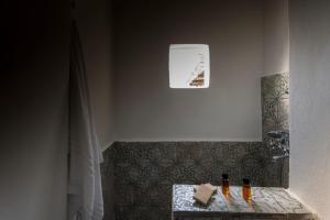 a bathroom with a shower with a table in it at La Sirena in Filicudi