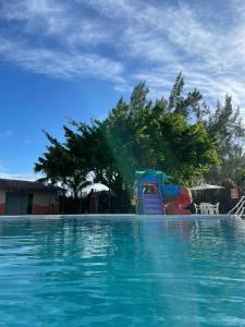 a water slide in the middle of a swimming pool at Arena Carneiros Hotel by AFT in Tamandaré