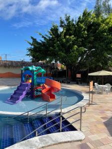 a water park with a slide in a pool at Arena Carneiros Hotel by AFT in Tamandaré