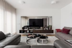 a living room with a couch and a coffee table at Modern 3BR with Terrace in Benfica in Lisbon