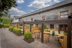 a restaurant with tables and chairs outside of a building at Court Yard Hotel in Leixlip