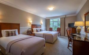 Voodi või voodid majutusasutuse Court Yard Hotel toas