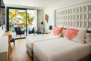 a hotel room with two beds and a balcony at Hotel Fariones in Puerto del Carmen