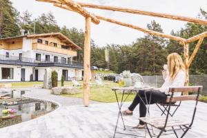 two women sitting at a table on the patio of a house at Sinnes Waldrast in Tarrenz