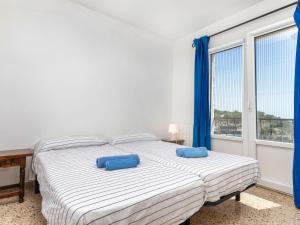 um quarto com 2 camas com almofadas azuis em Holiday Home Maragda by Interhome em Calonge