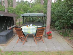 a table with two chairs and a gazebo at Holiday Home Enikö by Interhome in Lubmin