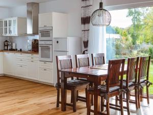 a kitchen with a wooden dining table and chairs at Holiday Home Pusteblume by Interhome in Hessenburg