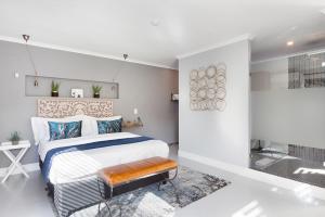 a bedroom with a king sized bed and a bathroom at Blouberg Studio Apartment in Bloubergstrand