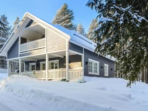 a house in the snow with snow covered trees at Holiday Home Mirkunranta by Interhome in Salla