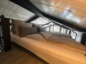 a large bed in the middle of a room at Holiday Home Tiny Haus Westerwald 16 Blue by Interhome in Bad Marienberg