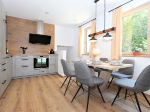 a kitchen with a dining room table and chairs at Apartment Bernadette by Interhome in Aschau