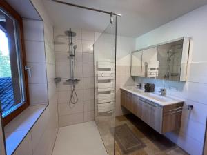 a bathroom with a sink and a glass shower at Holiday Home Haus Sigfried by Interhome in Bischofshofen