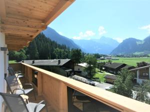 a balcony with chairs and a view of mountains at Apartment Geislerhof-1 by Interhome in Ramsau