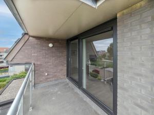 a balcony of a house with sliding glass doors at Apartment Rozenhof with parking by Interhome in Bredene