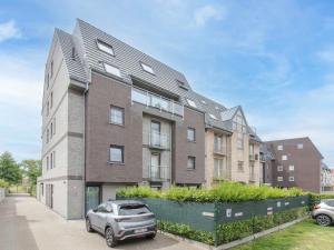 an apartment building with a car parked in front of it at Apartment Rozenhof with parking by Interhome in Bredene