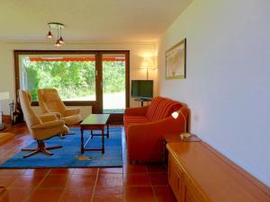 a living room with two chairs and a table at Apartment Victoria A-B-C-10 by Interhome in Crans-Montana