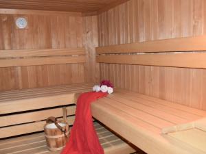 a sauna with two benches with a red scarf on them at Apartment Gams by Interhome in See