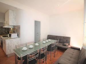 a living room with a table and chairs and a kitchen at Holiday Home Rainbow by Interhome in Benidorm
